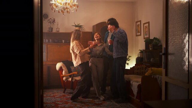 Group Of Friends Celebrating Together. Friends Gather Around Woman Raising Drinks High