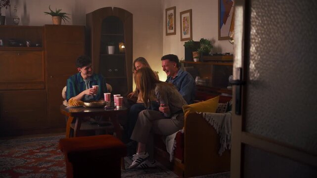 Cozy Ambiance With Friends Exchanging Stories Over Coffee And Treats While Smiling