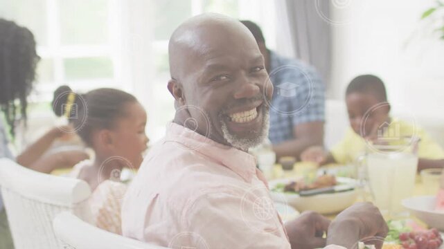 Vertical video: Dad turning to camera after family chat at table smiling as tech HUD tracking fork