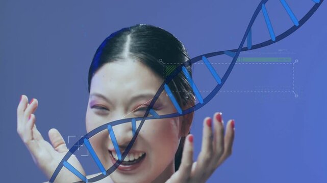 Woman laughing then covering face as DNA helix sliding over face causing playful biotech response