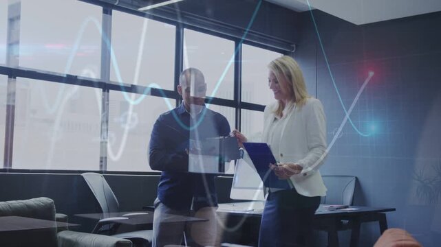 Man tapping tablet and woman pointing clipboard working in office, waveform drifting obscuring docs