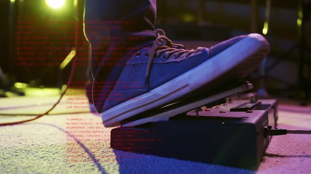 Vertical video: Male musician shifting onto effects pedal on carpet, pressing and modulating tone