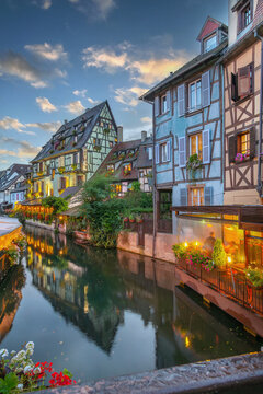 View of la Petite Venise district in Colmar, Alsace, France. Colorful timber framed houses under sunset sky and clouds