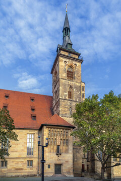 Bell tower of Stiftskirche church in Stuttgart, Germany. Gothic architecture of the historical landmark under cloudy sky