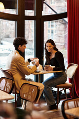 Fototapeta premium Romantic young couple enjoying a special moments at an elegant restaurant
