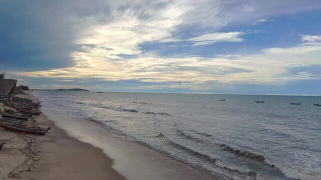 Traditional Fishing Boats on a Tranquil Brazilian Beach at Dusk with Dramatic Sky