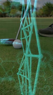 Vertical video: Male golfer drawing back, striking ball, making teal AR lattice shift toward hole