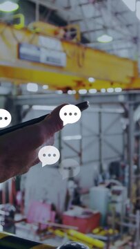Vertical video: Tech hand entering with phone bringing chat bubbles over crane syncing plant tasks