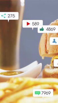 Vertical video: On frame two badges popping over burger, fries and beer, boosting food marketing