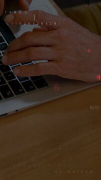Vertical video: Dev hands moving onto laptop keys and typing, coding overlay appearing across keys