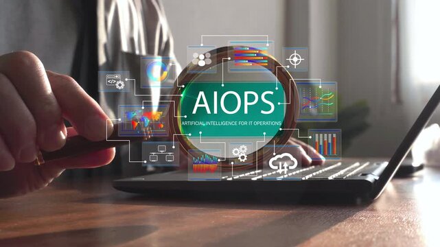 Close-up of a magnifying glass focusing on an AIOPS interface above a laptop, symbolizing AI-driven IT operations, monitoring, automation, cloud infrastructure, and performance analysis.