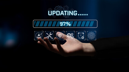 Human hand reaching out to an interface with a progress bar indicating software updating status at...