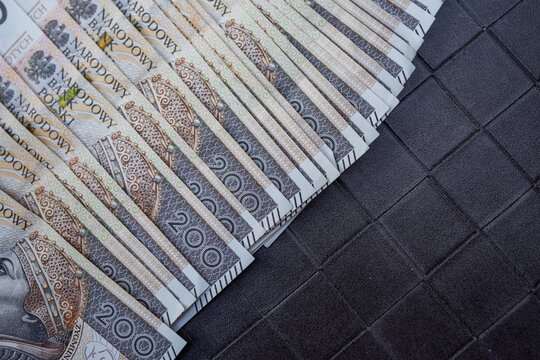 Heap of 200 PLN Polish Zloty Bills Scattered on Surface for Banking and Investment Marketing