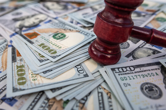 Judicial Gavel on US Dollars Background for Business Arbitration and Financial Dispute Resolution