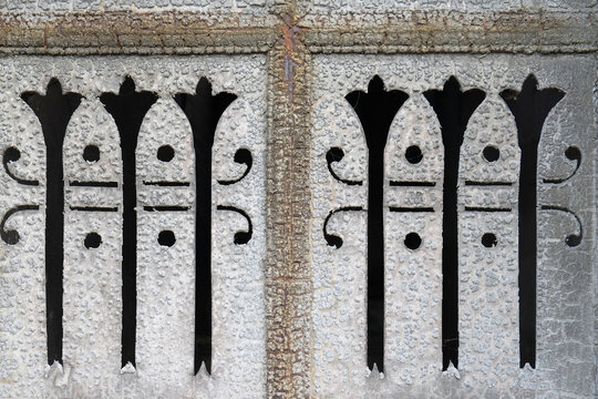 Weathered cutout metal pattern with textured surface