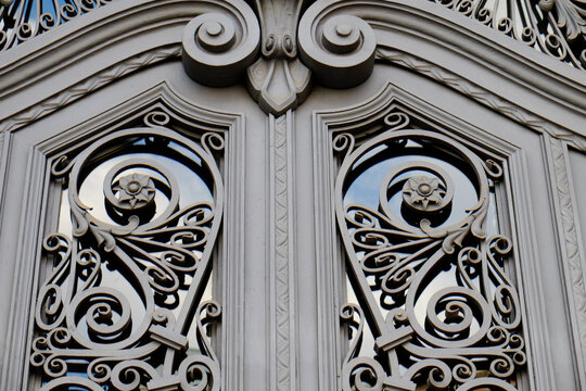 Gray wrought iron scrollwork door detail
