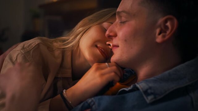 Tender moment of romantic couple sharing closeness in cozy home living room