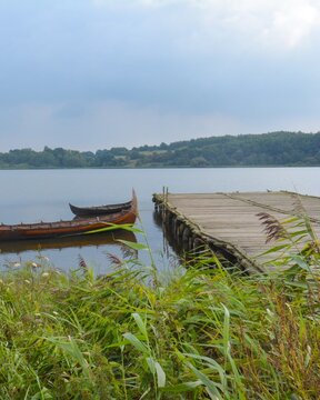 Viking boats at historical pier in haithabu, ringwall, germany