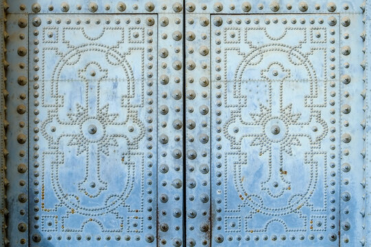 Pale blue studded ornamental door pattern
