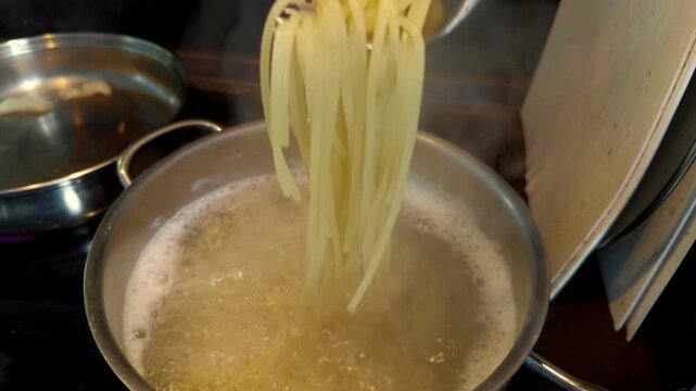 Boiling Long Pasta In Saucepan. Cooking Italian Dinner. Mediterranean Cuisine