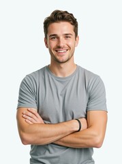 Fototapeta premium Smiling young man standing with arms crossed on a white background. Confident casual male wearing a grey t-shirt looking at camera