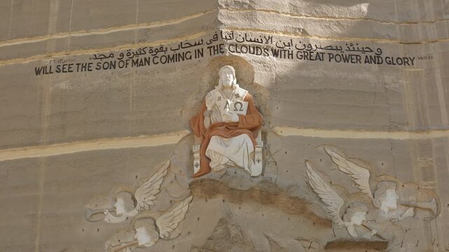 Rock wall decorated with carved bas-reliefs and sculptures of saints in cave complex of Monastery of Saint Simeon Shoemaker in Cairo.