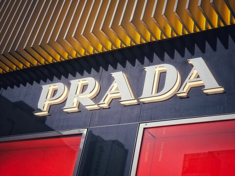 Luxury Fashion Store Exterior with Prada Logo Sign and Red Display Windows on March 31 2026 in Chengdu, China.	
