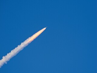 April 1, 2026 Artemis II  rocket launch climbing  with trailing thin bright flaming exhaust gasses © JohnBlottman