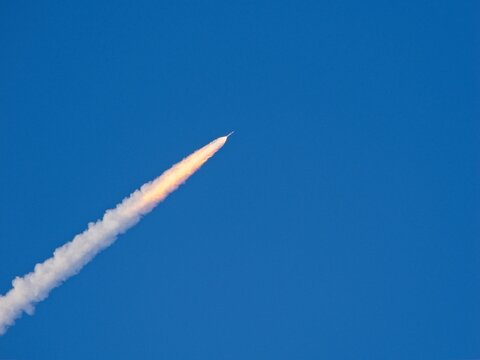 April 1, 2026 Artemis II  rocket launch climbing  with trailing thin bright flaming exhaust gasses
