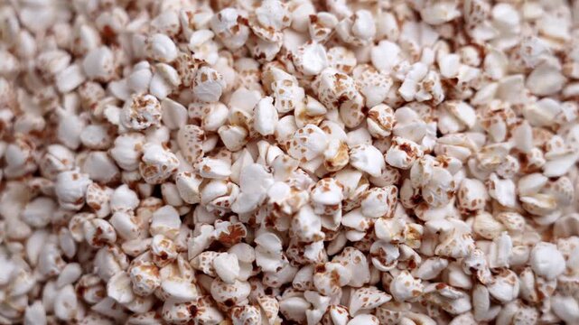 Close up of puffed buckwheat grains. Gluten free organic cereal ingredient. Rotation