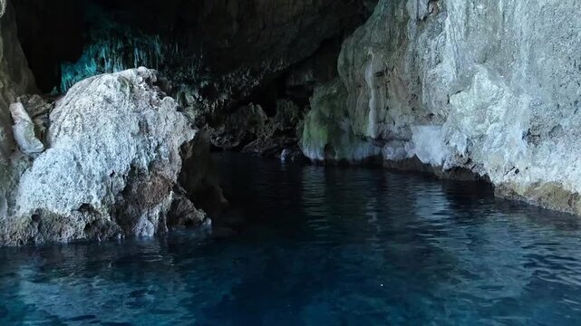 Turkiye, Belek, 27.07.2025 Sea cave in Mediterranean coast with clear blue water. Stone grotto with natural light reflections in Turkey. Exploration of cavern for summer holiday travel.