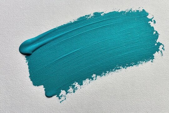 A textured teal paint stroke across a white textured paper background, abstract artistic brush mark.