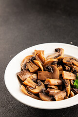 Fototapeta premium Champignon mushrooms ready to eat tasty snack fresh gourmet food background on the table rustic food top view copy space keto and paleo diet vegetarian and vegan food marketing concept photo
