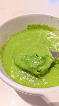 Spoon picking up spinach cream soup, Rustic Italian French Food Cuisine, Gourmet Tasty Healthy Diet, Slow Motion