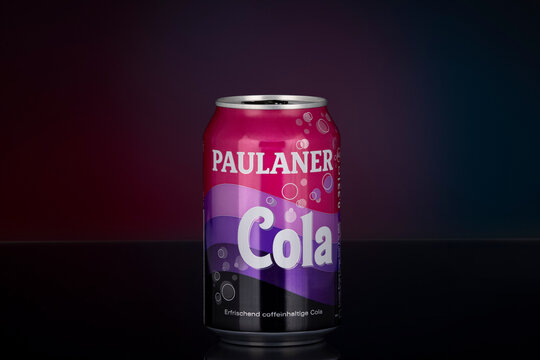 Paulaner Cola caffeinated soft drink can photographed on dark gradient background. German beverage brand aluminum can shown as illustrative editorial content.