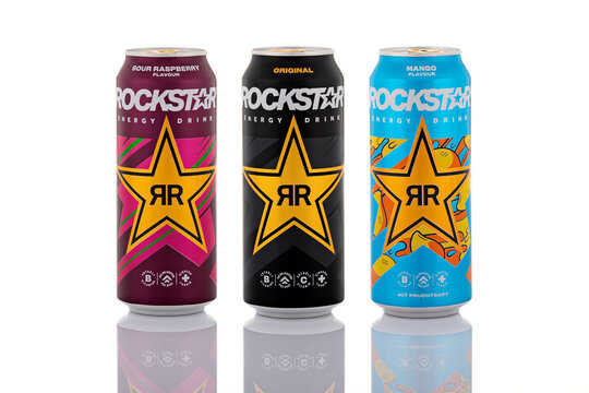 Assorted Rockstar Energy Drink cans including mango, original and sour raspberry flavors isolated on white background. Branded caffeinated beverages shown as illustrative editorial