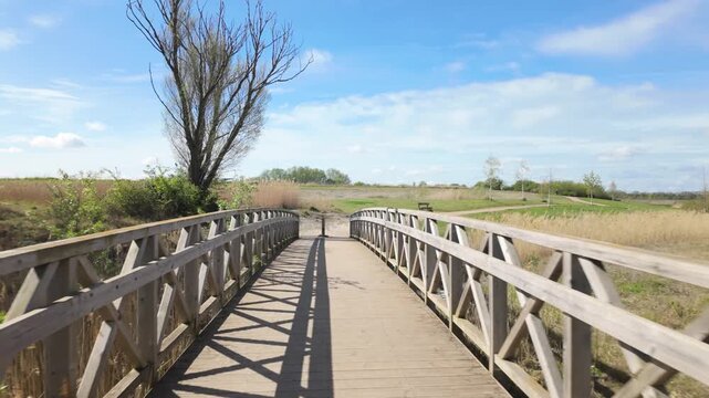 Beeby's Lake West, Peterborough UK - April 14 2026: PoV sequence, no talking, no people, on a bright spring day walking over the foot bridge.