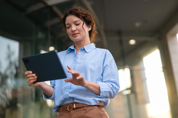 Businesswoman using digital tablet for modern communication outdoors © Dexon Dee