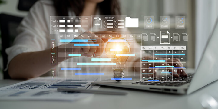 A business professional engages with a laptop, utilizing a digital interface for project management, enhancing productivity through effective task and schedule visualization. Gantry