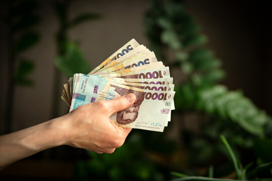 A man is holding money in his hands, Ukrainian currency close-up.