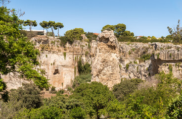 Fototapeta premium The Latomia del Paradiso inside the Neapolis Archaeological Park in Syracuse, Sicily, Italy. Historic archaeological site connected to Greek and Roman history.