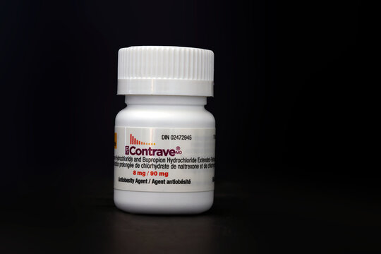 Calgary, Alberta, Canada. April 14, 2026. A white plastic bottle of Contrave antiobesity medication with a prescription label on a black background.
