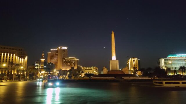 Famous Ramses II obelisk and Tahrir Square with traffic ,  evening view, Cairo, Egypt