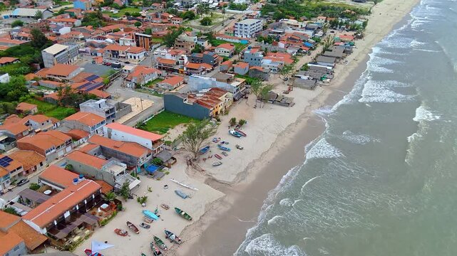 Aerial View of Brazilian Coastal Fishing Village with Colorful Boats and Ocean Waves