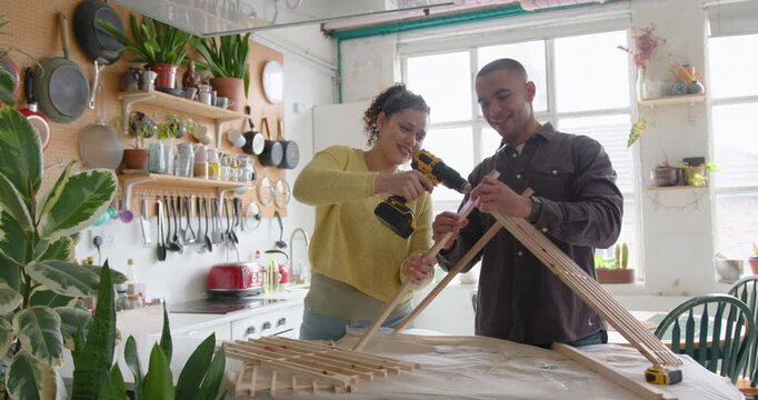 Young Couple Building a DIY Project Together in Kitchen