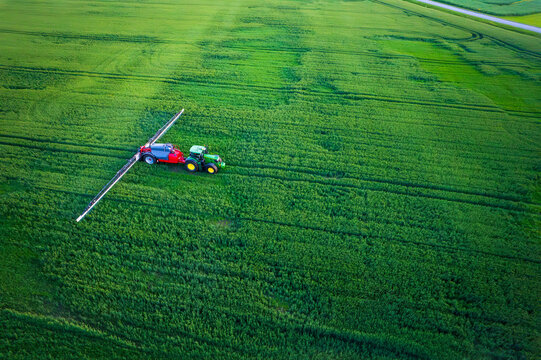 Aerial view of a tractor with a sprayer in a field