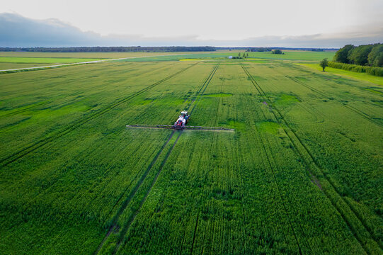 Aerial view of a tractor with a sprayer in a field