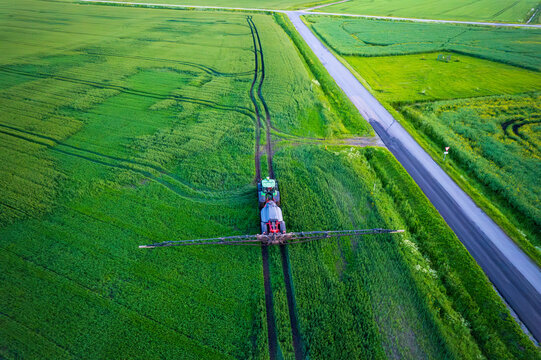 Aerial view of a tractor with a sprayer in a field