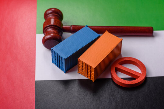 The cargo container ban on the UAE flag as a conceptual backdrop. The cargo container embargo