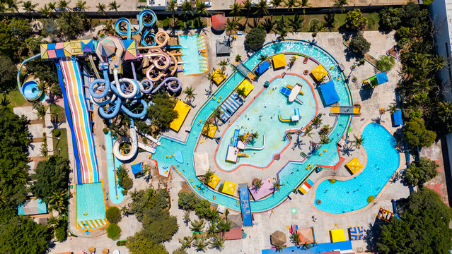 Aerial view of the vibrant waterpark with slides and pools, a tapestry of blues and yellows under the sun, Riviera Nayarit, Mexico